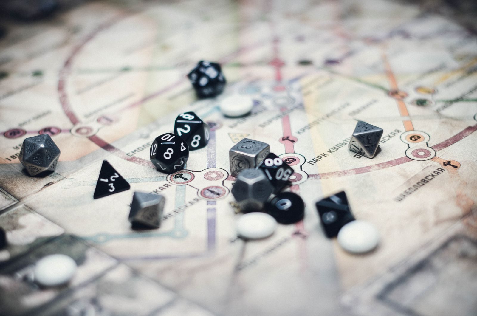 Multi-sided role-playing dice scattered across a detailed tabletop game map.